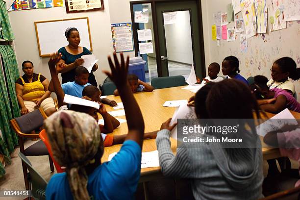 Children answer questions during scripture study hour at the Center of Hope shelter for homeless women and children on June 16, 2009 in Dallas,...