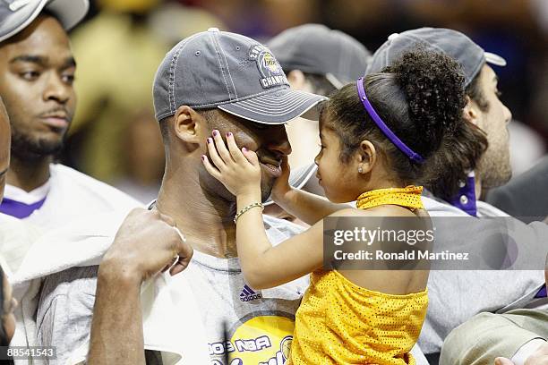 Kobe Bryant of the Los Angeles Lakers holds his daughter, Gianna, after the Lakers defeated the Orlando Magic in Game Five of the 2009 NBA Finals on...