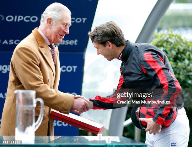 Prince Charles, Prince of Wales presents Harry Meade with his prize for taking part in the The Prince's Countryside Fund Charity Race at Ascot...