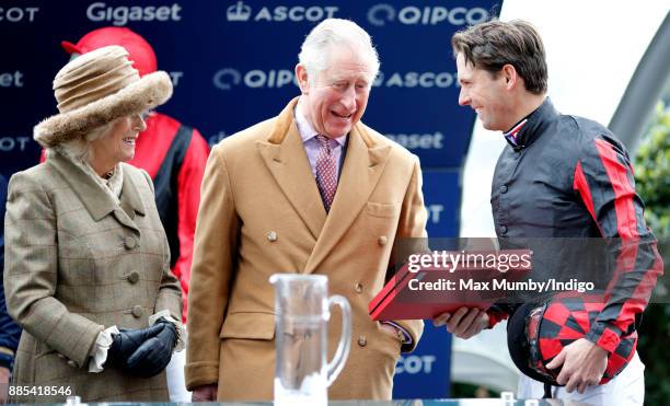 Camilla, Duchess of Cornwall and Prince Charles, Prince of Wales present Harry Meade with his prize for taking part in the The Prince's Countryside...