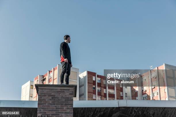 man practicing parkour in the city - zenith building stock pictures, royalty-free photos & images