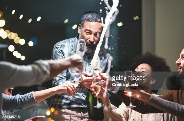champagne celebration toast. - new year's eve dinner stock pictures, royalty-free photos & images