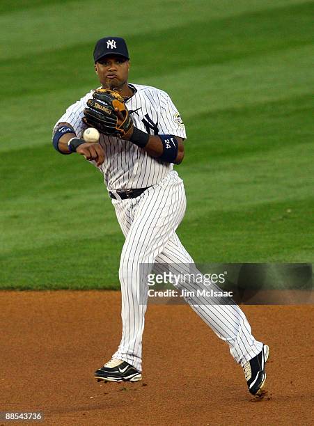 Robinson Cano of the New York Yankees throws to first base for an out against the Washington Nationals on June 17, 2009 at Yankee Stadium in the...