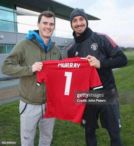 Zlatan Ibrahimovic of Manchester United poses with tennis player Jamie Murray ahead of a first team training session at Aon Training Complex on...