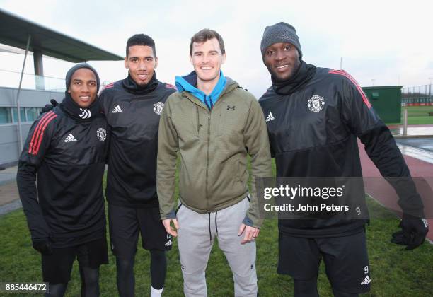 Ashley Young, Chris Smalling and Romelu Lukaku of Manchester United pose with tennis player Jamie Murray ahead of a first team training session at...