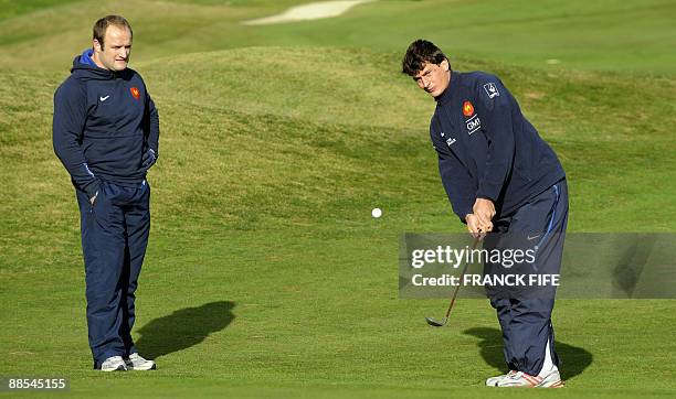 French rugby players Wiilliam Servat and Yanncik Jauzion play golf at the Miramar Golf Course in Wellington on June 18, 2009. France on June 17 made...