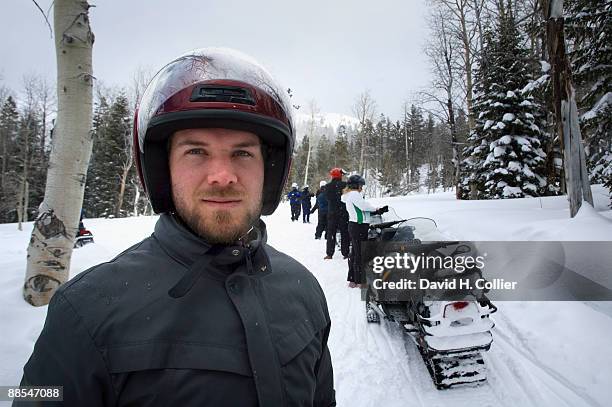 man with snowmobiles in forest - man wearing helmet stock pictures, royalty-free photos & images