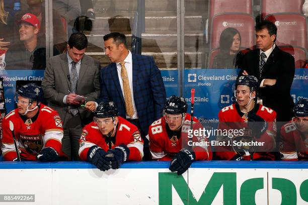 Florida Panthers Head Coach Bob Boughner chats with Assistant Coach Paul McFarland while Associate Coach Jack Capuano looks on during a break in the...