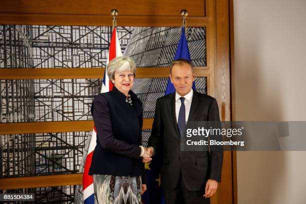 Theresa May, U.K. Prime minister, left, shakes hands with Donald Tusk, president of the European Union , while standing for photographs following a...