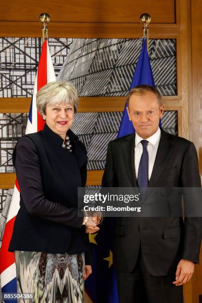 Theresa May, U.K. Prime minister, left, shakes hands with Donald Tusk, president of the European Union , while standing for photographs following a...