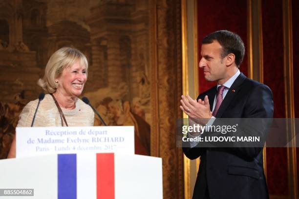French president Emmanuel Macron applaudes to Evelyne Richard who gives a speech as she retires from the Elysee palace press office after 48 years of...