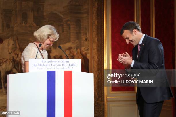 French president Emmanuel Macron applaudes to Evelyne Richard who gives a speech as she retires from the Elysee palace press office after 48 years of...