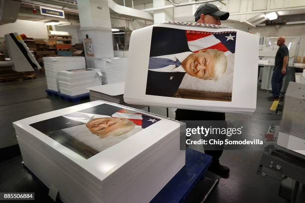 Government Publishing Office bookbinder Ronny Varnell stacks copies of the official photograph of President Donald Trump December 4, 2017 in...