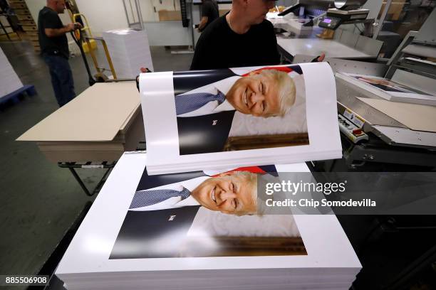 Government Publishing Office bookbinder Ronny Varnell stacks copies of the official photograph of President Donald Trump December 4, 2017 in...