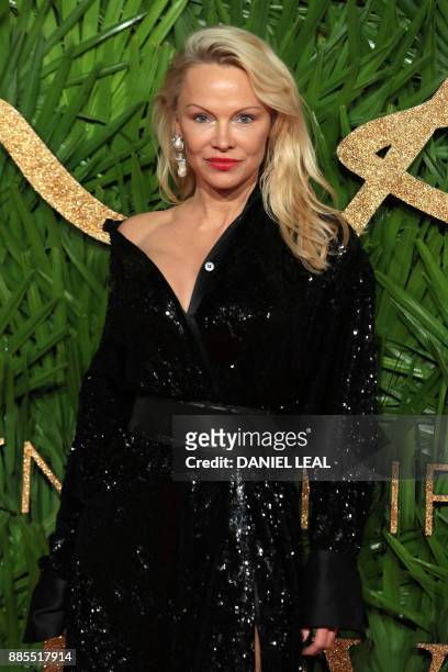 Canadian American actress, Pamela Denise Anderson poses on the red carpet upon arrival to attend the British Fashion Awards 2017 in London on...