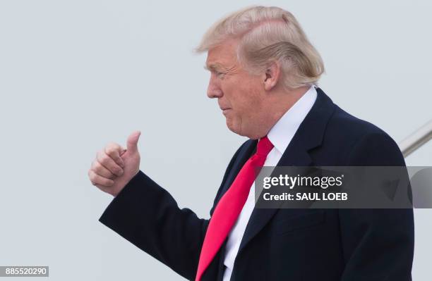 President Donald Trump disembarks from Air Force One upon arrival at Salt Lake City International Airport in Utah, December 4, 2017. / AFP PHOTO /...