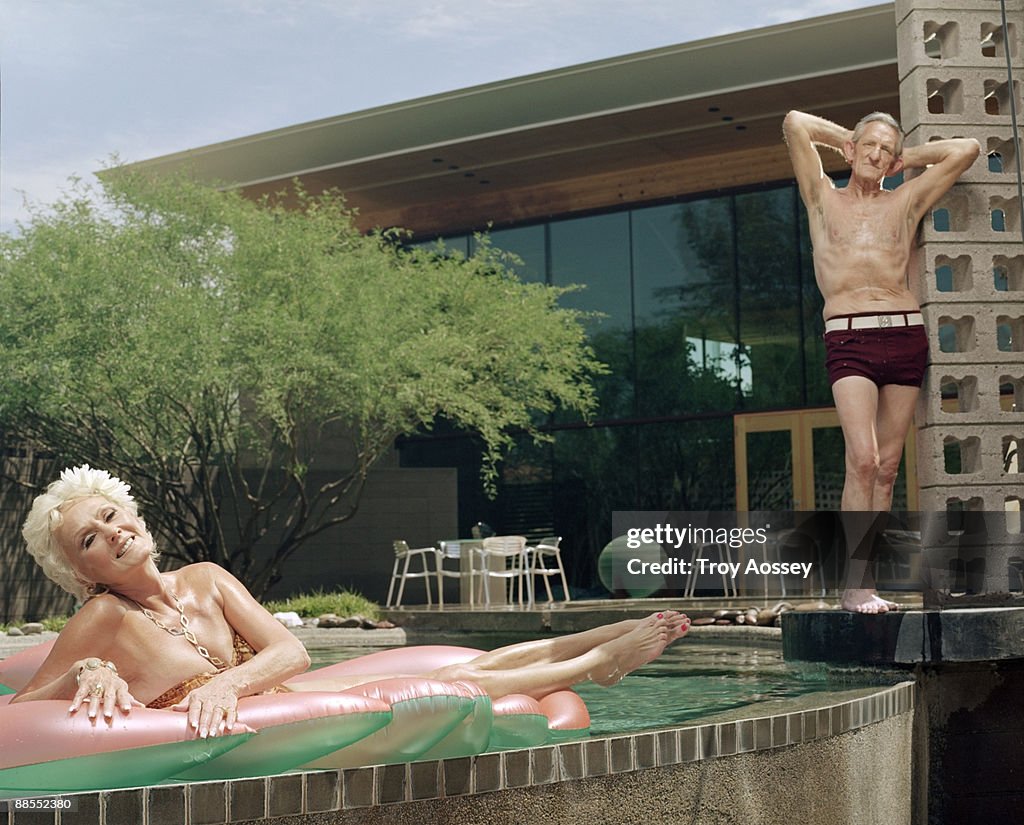 Fit couple posing by the pool