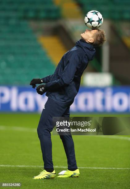 Lukasz Teodorczyk balances a ball on his head during an Anderlecht training session on the eve of their UEFA Champions League match against Celtic at...