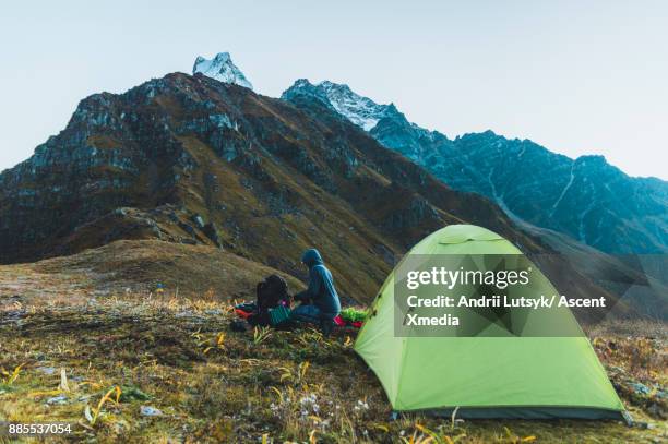 young woman pauses beside tent, in mountains - 1040 2017 stock pictures, royalty-free photos & images