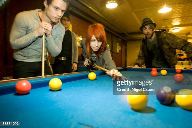 Left to right Josh Farro, Zac Farro, Hayley Williams and Jeremy Davis of American band Paramore playing pool backstage at the Apollo in Manchester,...