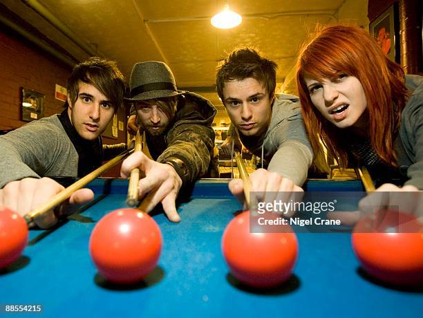 Left to right Zac Farro, Jeremy Davis, Josh Farro and Hayley Williams of American band Paramore playing pool backstage at the Apollo in Manchester,...