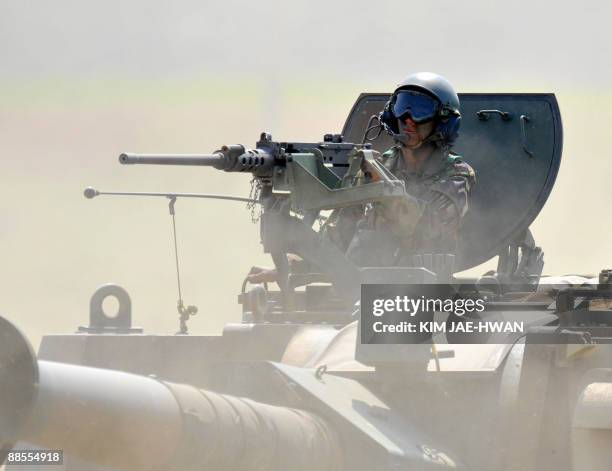 South Korean soldier sits in the turret of a K-9 155mm self-propelled howitzer for a shooting exercise in Yeoncheon, north of Seoul, near the tense...