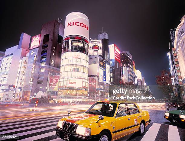 yellow taxi waiting at the ginza shopping district - yellow taxi ストックフォトと画像