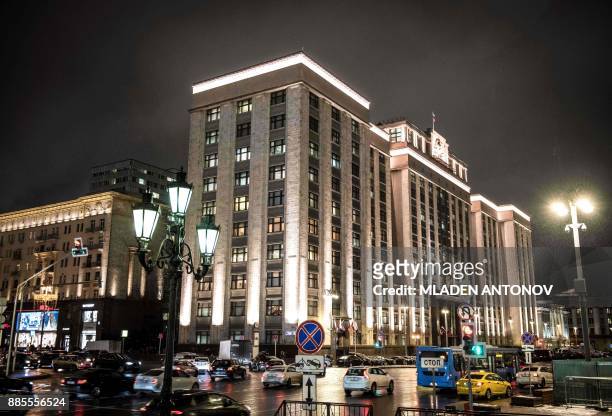 Cars drive in front of the headquarter building housing the State Duma, the Lower House of the Federal Assembly of the Russian Federation, in Moscow...