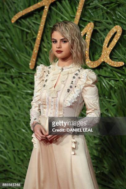 American actress Selena Gomez poses on the red carpet upon arrival to attend the British Fashion Awards 2017 in London on December 4, 2017.