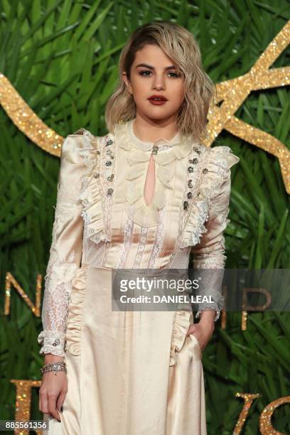 American actress Selena Gomez poses on the red carpet upon arrival to attend the British Fashion Awards 2017 in London on December 4, 2017.