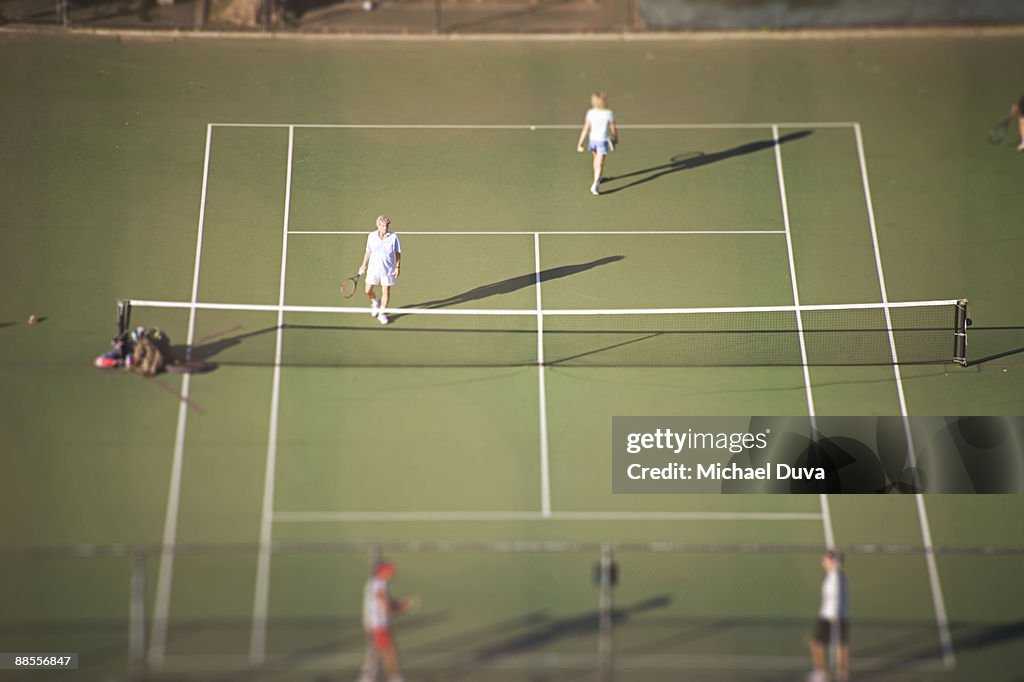 Doubles tennis aerial view on public courts