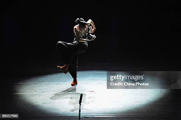 Chinese artist Yang Liping performs on stage in percussion dance "Sound of Yunnan" at the Qintai Grand Theatre on June 16, 2009 in Wuhan of Hubei...