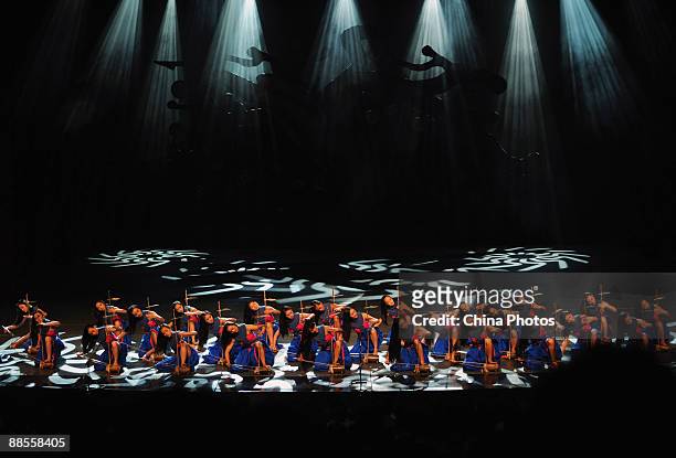 Artists perform during percussion dance "Sound of Yunnan" at the Qintai Grand Theatre on June 16, 2009 in Wuhan of Hubei Province, China. The dance...