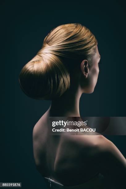 portrait of a young woman wearing a bun, back - woman lipstick rearview stock-fotos und bilder