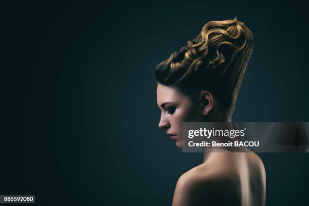 portrait of a young woman wearing a bun, profile - lock of hair stock pictures, royalty-free photos & images