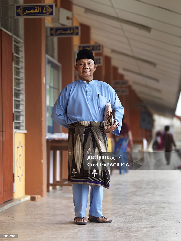 A stand posing in his traditional garb. 