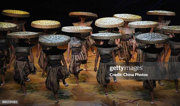 Artists perform during percussion dance "Sound of Yunnan" at the Qintai Grand Theatre on June 16, 2009 in Wuhan of Hubei Province, China. The dance...