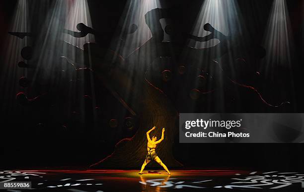 Artists perform during percussion dance "Sound of Yunnan" at the Qintai Grand Theatre on June 16, 2009 in Wuhan of Hubei Province, China. The dance...