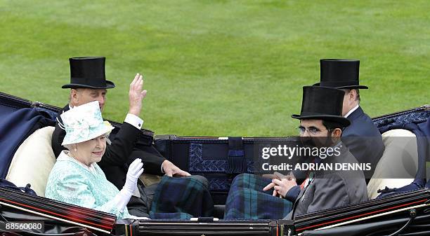 Britain's Queen Elizabeth II and her husband The Duke of Edinburgh sit opposite Mohammed bin Rashid Al Maktoum as they arrive for the days' racing...