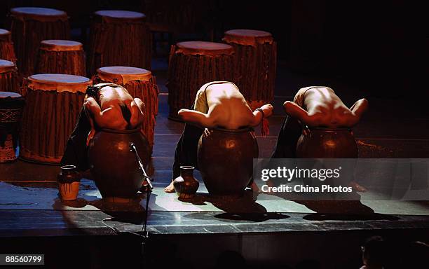 Artists perform during percussion dance "Sound of Yunnan" at the Qintai Grand Theatre on June 16, 2009 in Wuhan of Hubei Province, China. The dance...