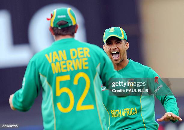 South Africa's Jean-Paul Duminy congratulates South Africa's Roelof van der Merwe after he caught out Pakistan's Shahzaib Hasan for 0 runs during the...