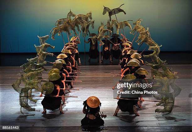 Artists perform during percussion dance "Sound of Yunnan" at the Qintai Grand Theatre on June 16, 2009 in Wuhan of Hubei Province, China. The dance...