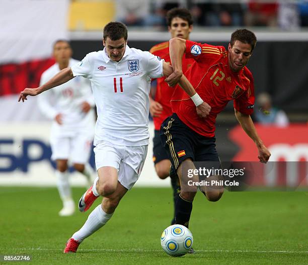 Adam Johnson of England gets tackled by Cesar Azpilicueta of Spain during the UEFA U21 European Championships match between England and Spain at the...