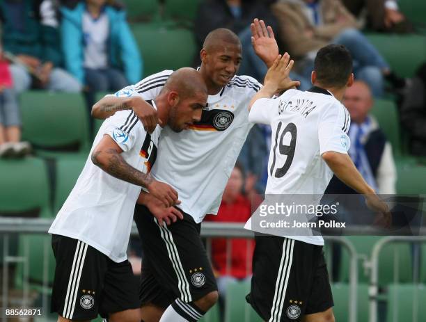 Ashkan Dejagah of Germany celebrates with his teams mate Aenis Ben-Hatira and Dennis Aogo after scoring his team's second goal during the UEFA U21...