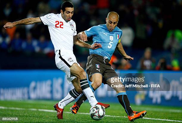 Mohammed Aboutrika of Egypt holds off Fabio Cannavaro of Italy during the FIFA Confederations Cup Group A match between Egypt and Italy at the Ellis...