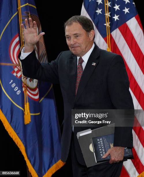 Utah Governor Gary Herbert waves to the crowd as he arrives to an event where U.S. President Donald Trump will speak at the Rotunda of the Utah State...