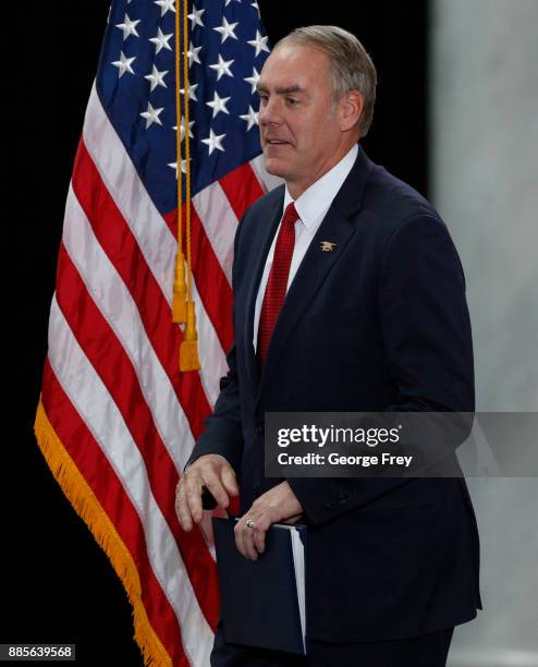 Interior Secretary Ryan Zinke walks on stage to give a speech before U.S. President Donald Trump arrives at the Rotunda of the Utah State Capitol on...