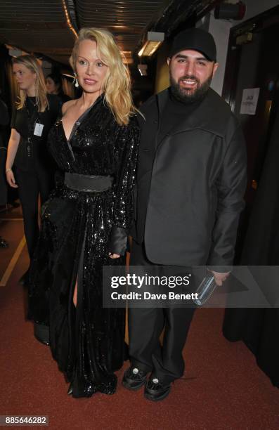 Pamela Anderson and Michael Halpern, winner of the British Emerging Talent Womenswear award for Halpern, pose backstage at The Fashion Awards 2017 in...