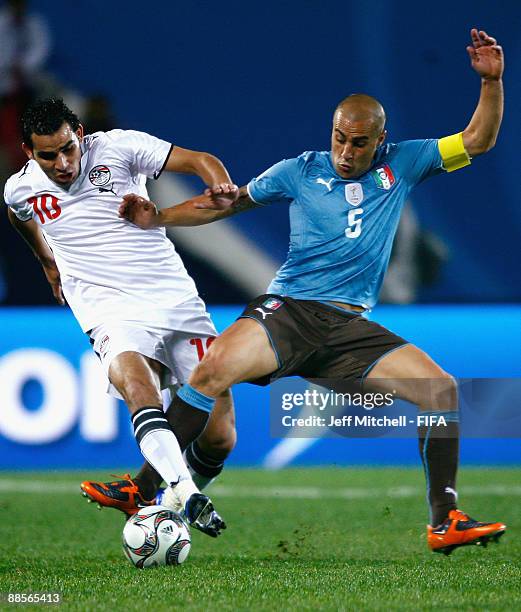 Ahmed Eid of Egypt tackles Fabio Cannavaro of Italy during the FIFA Confederations Cup match between Egypt and Italy at Ellis Park Stadium on June...