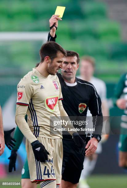 Referee Zoltan Ivanyi shows the yellow card for Marko Scepovic of Videoton FC during the Hungarian OTP Bank Liga match between Ferencvarosi TC and...